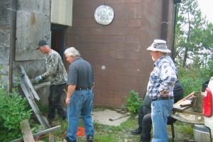 Mike, removing the old stairway while Darrell, Simon and Bill lookon